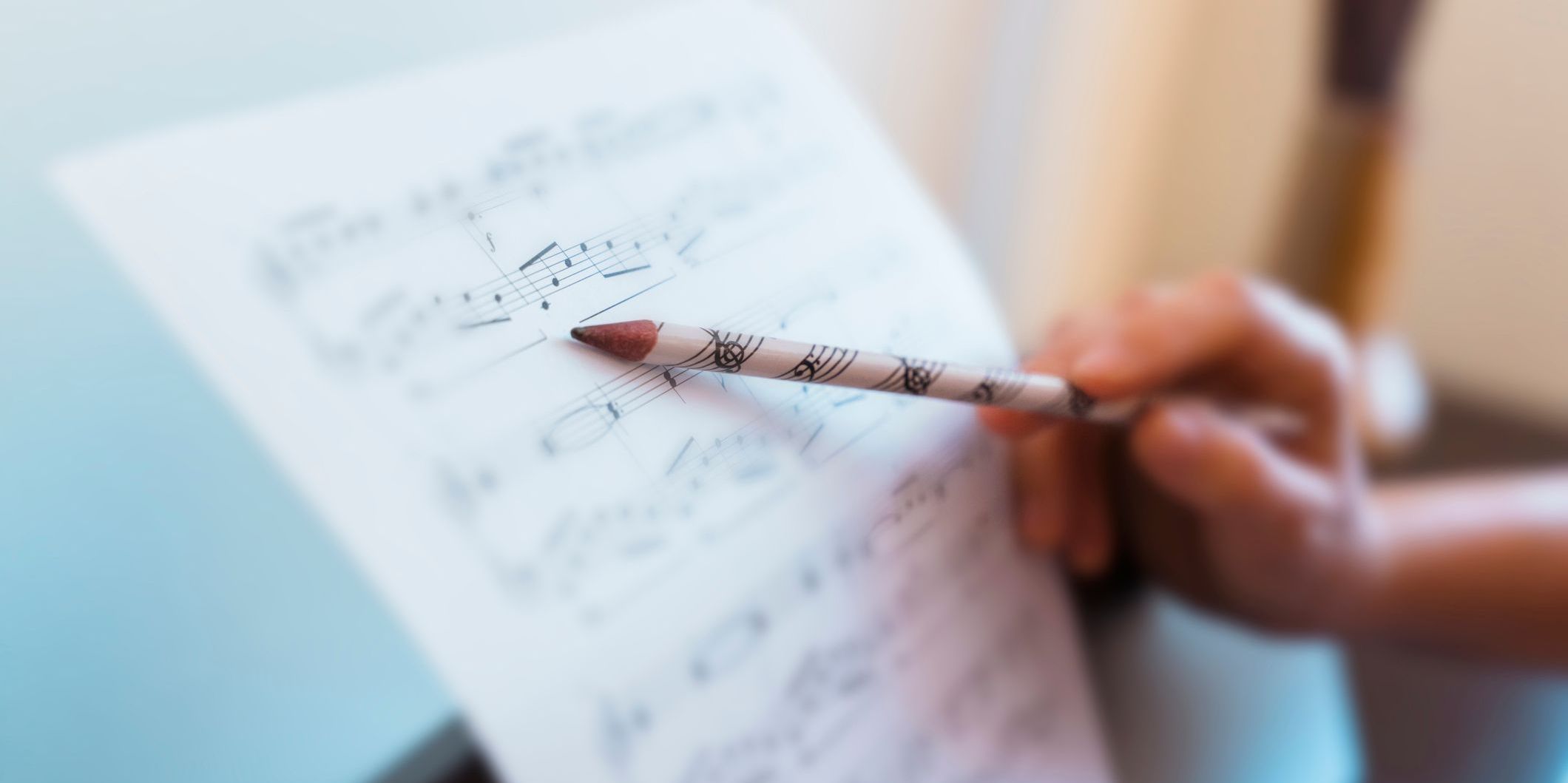 A music theory instructor showing a student sheet music.