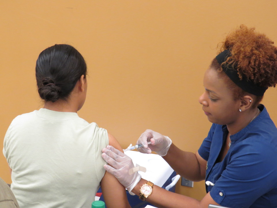 A photo of a nurse administering a vaccination.