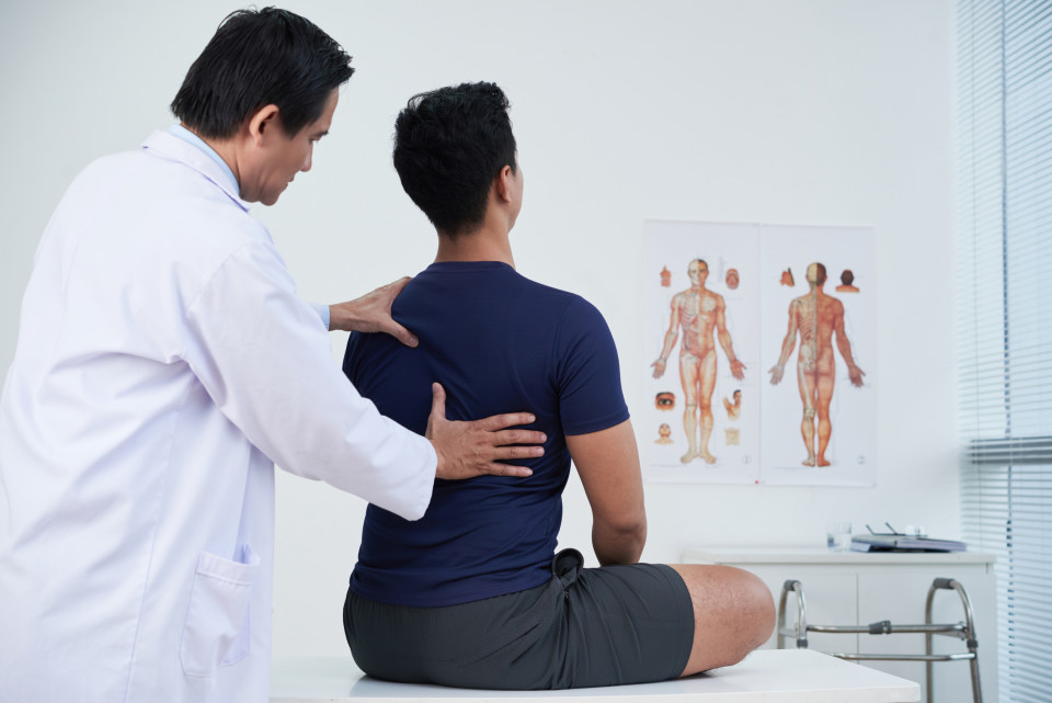 A photo of a chiropractor examining a patient.