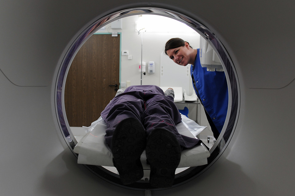 A photo of a neuropsychologist with her patient in an MRI machine.