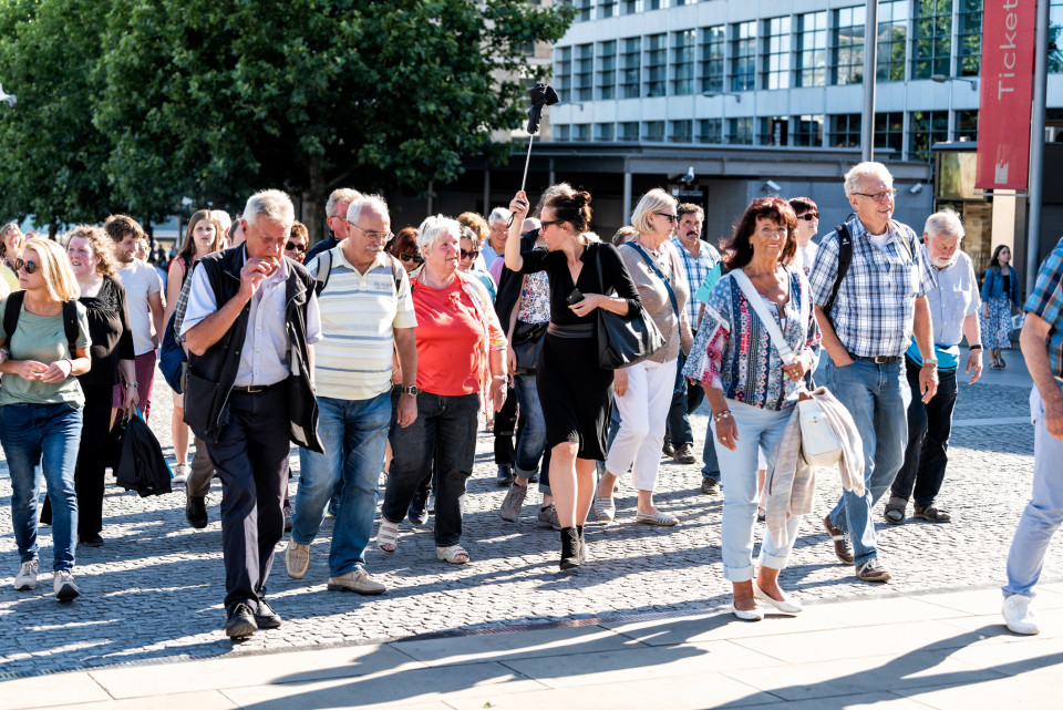 A photo of a tour guide leading a group of tourists.