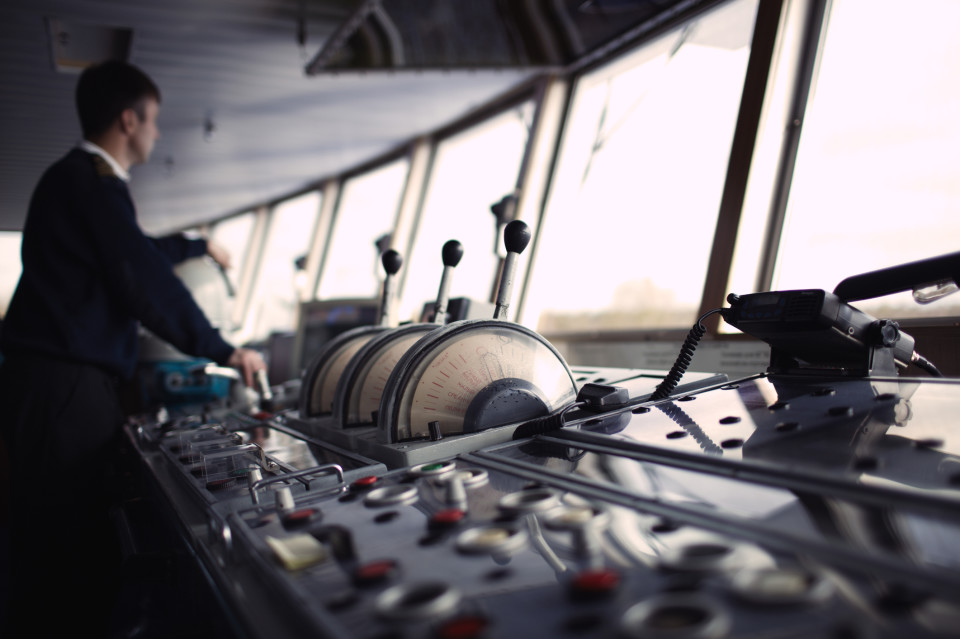 A photo of a yacht crew member aboard the bridge.