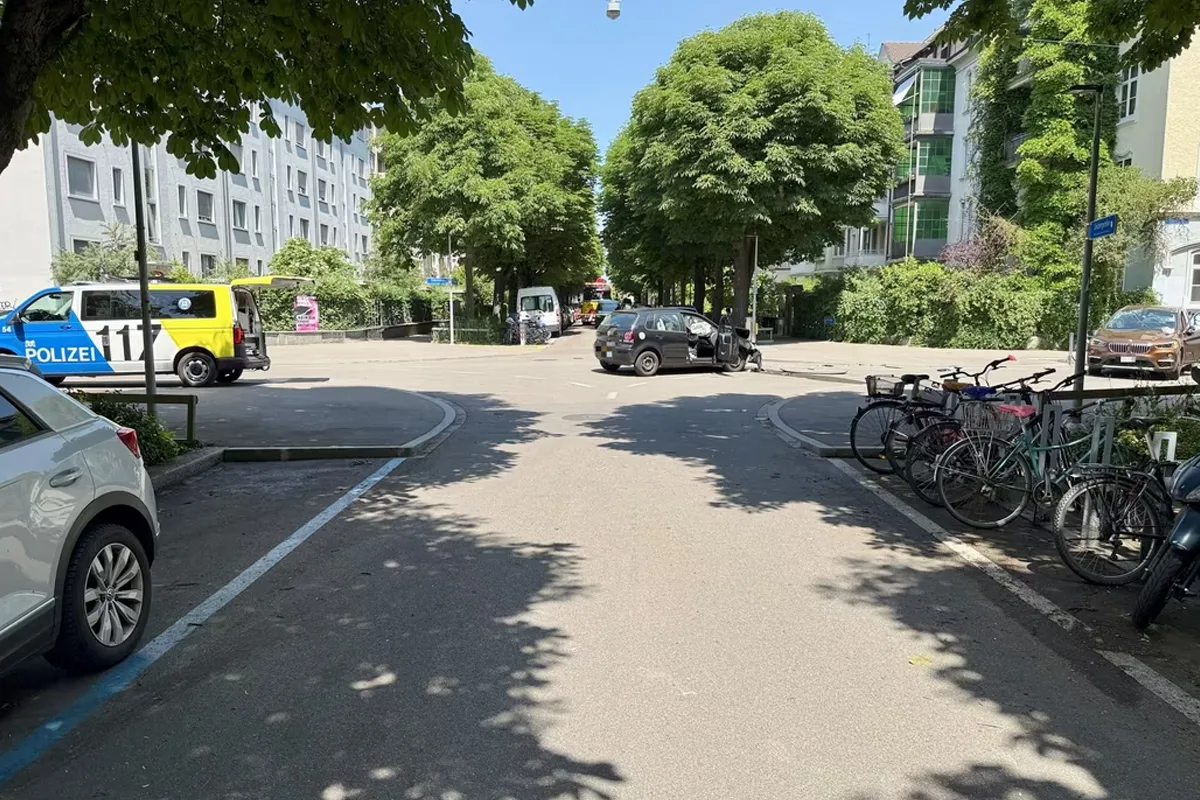 Eine Straßenecke in einem Wohngebiet ist mit einem Polizeiwagen und mehreren Fahrrädern an einem sonnigen Tag zu sehen.