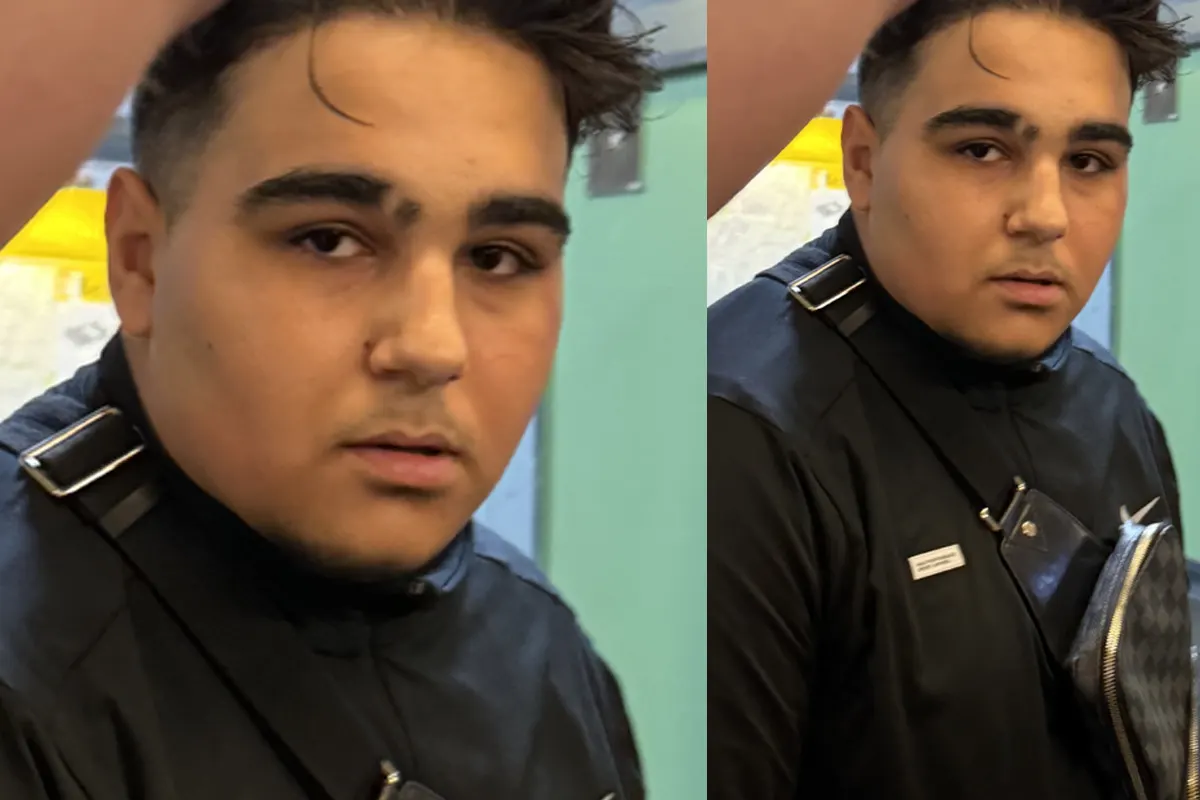Das Bild zeigt eine nahaufnahme einer Person in schwarzer Kleidung mit einer Tasche im Vordergrund. Dahinter ist ein verschwommener Hintergrund zu sehen.