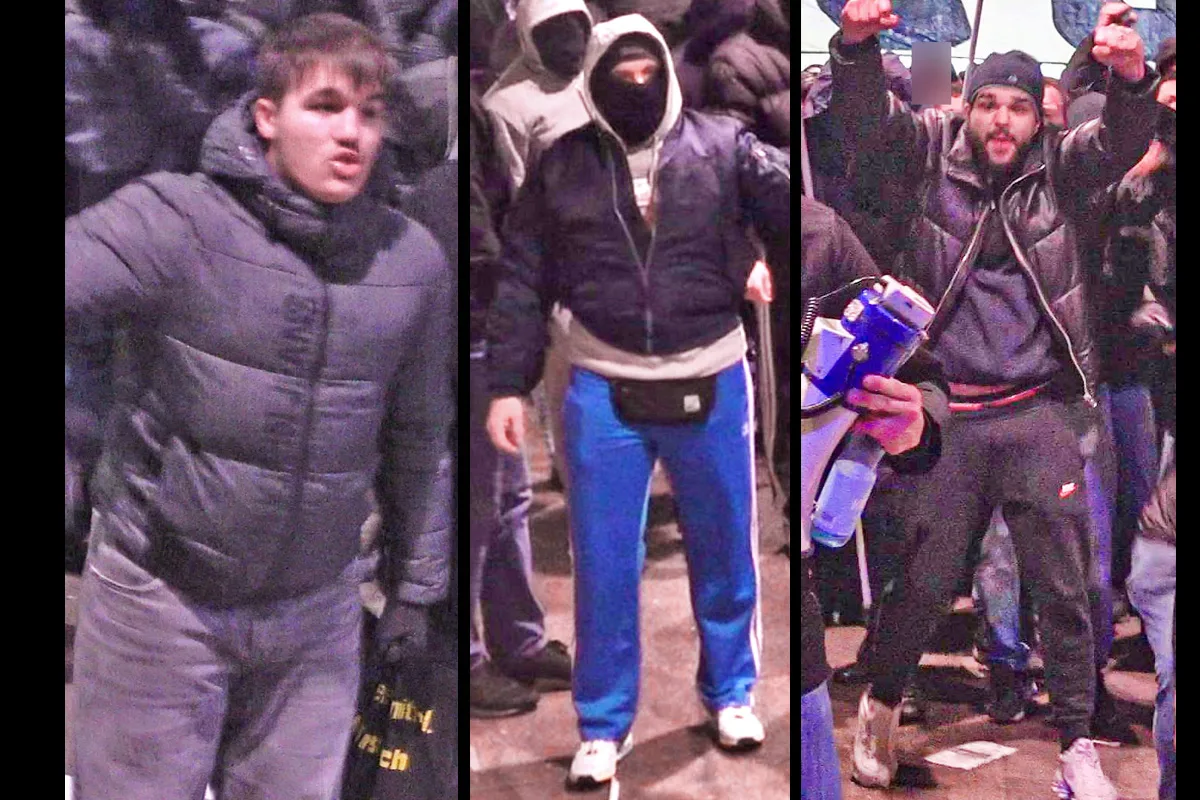 Bild zeigt drei junge Männer in winterlicher Kleidung, die in einer Menschenmenge während einer Kundgebung stehen.