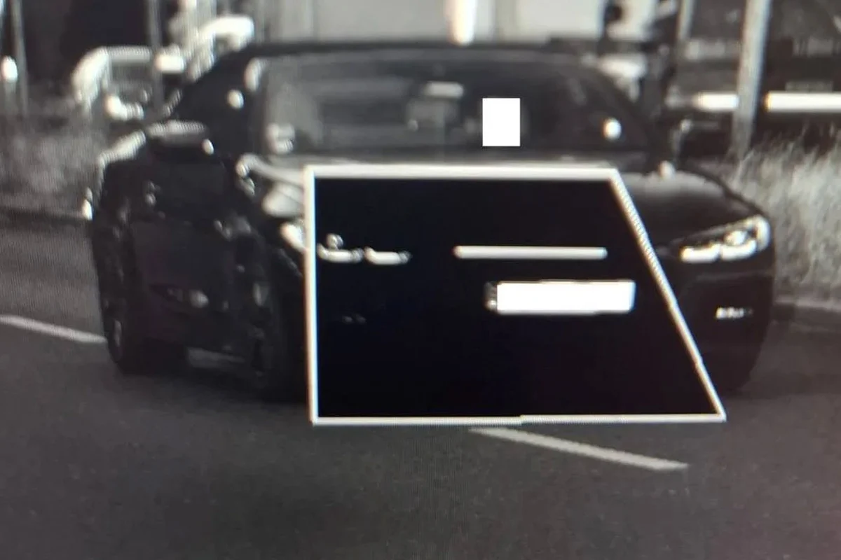 Ein Auto wird auf einer Straße durch eine Radarkamera erfasst. Das Kennzeichen ist in einem rechteckigen Bereich unkenntlich gemacht.