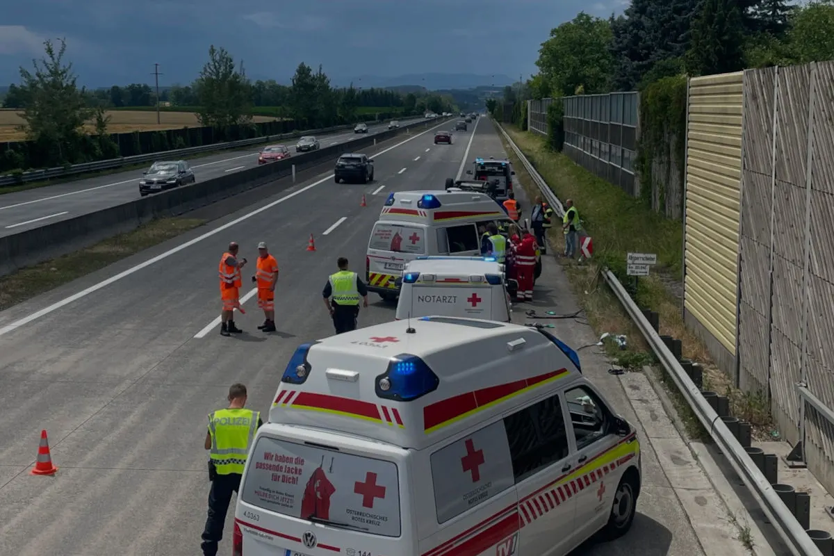 Zwei Krankenwagen stehen auf einer Autobahn. Polizisten und Rettungskräfte sind vor Ort, um die Unfallstelle abzusichern.