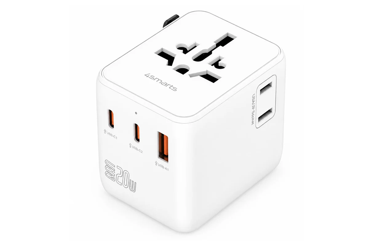 Das Bild zeigt einen weißen Reiseadapter mit mehreren USB-Anschlüssen, der von der Marke 4smarts ist. Der Adapter hat eine universelle Steckdose und drei USB-Ports.