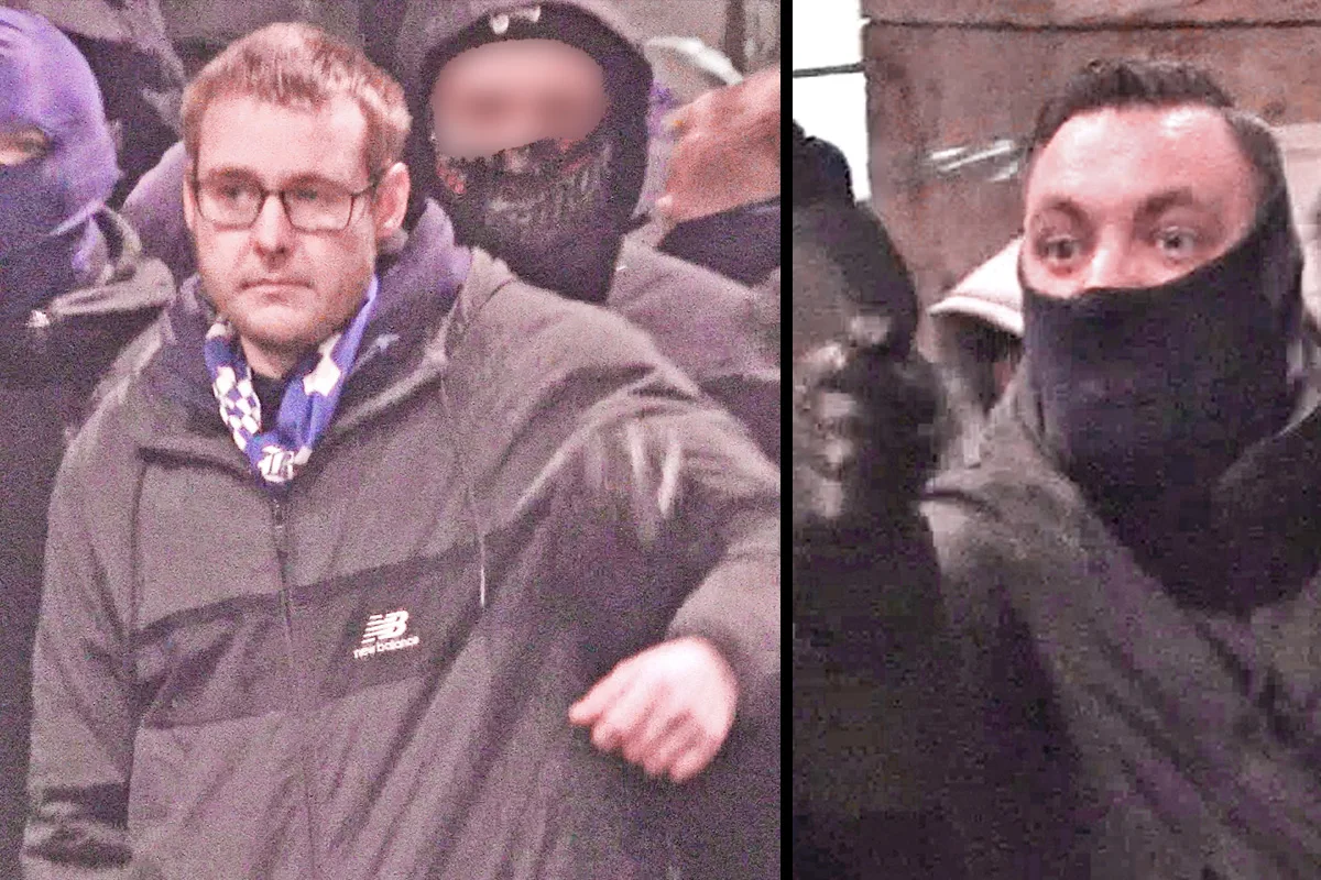 Das Bild zeigt zwei maskierte Männer in Nahaufnahme. Einer hat eine Brille, beide wirken angespannt.