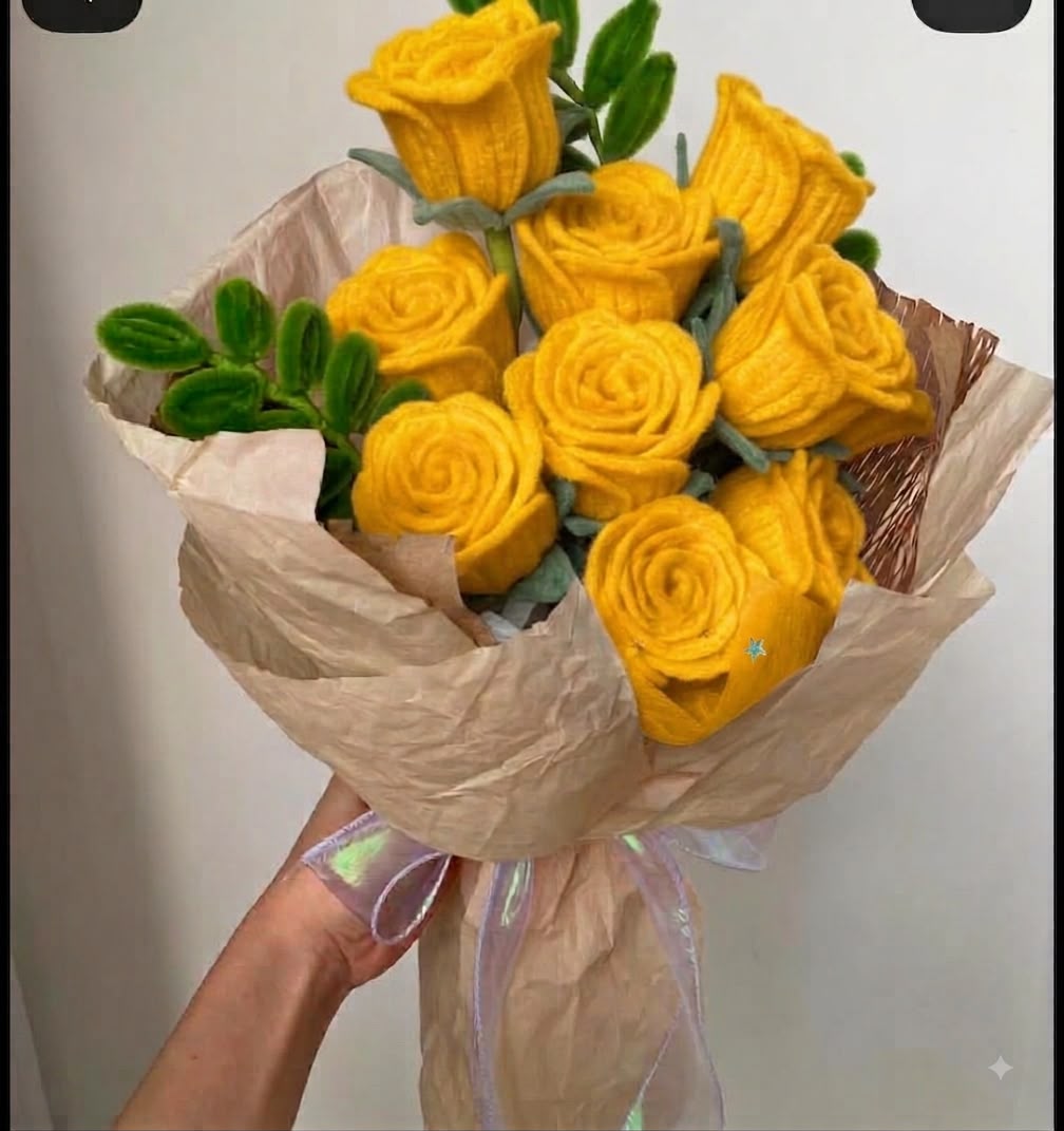 Yellow pipe cleaner rose bouquet held in hand