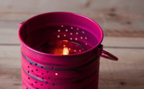 Rosa angemalte Dose mit Löchern und Teelicht