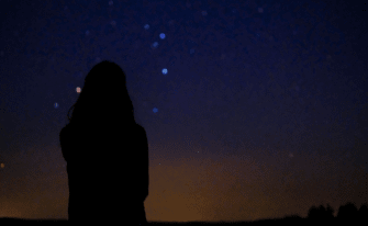 Frau schaut in den Himmel