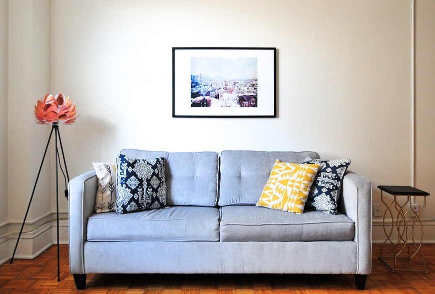 Solid Color Blue Sofa with multi color pattern pillows