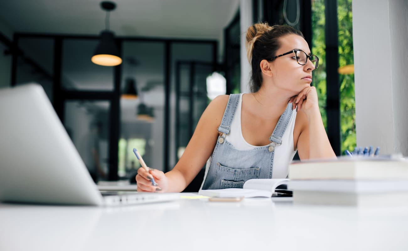 A woman procrastinating at her desk