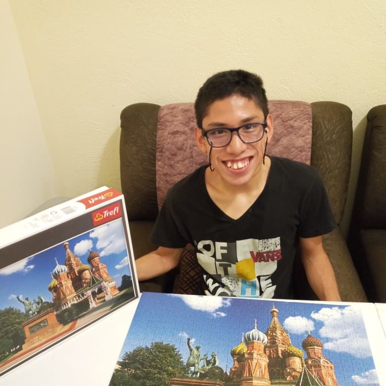 Carlos with a finished puzzle