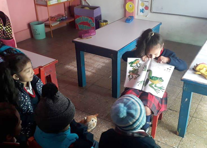 child reading to class