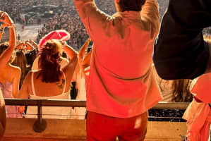 Guest at a concert with love heart sign