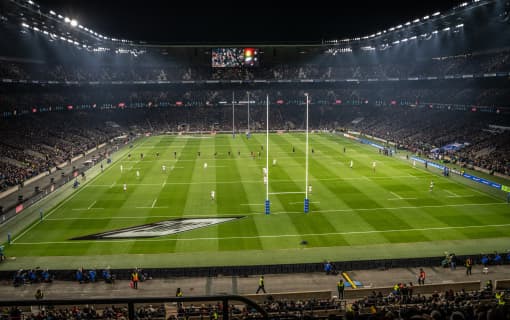 Rugby pitch with packed seats.