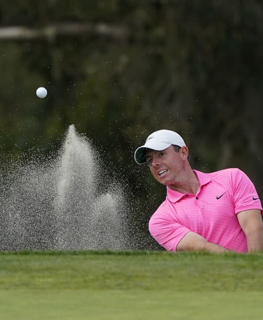 Rory McIlroy chips out of the bunker