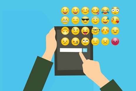 A person selecting emojis. A person selecting emojis.