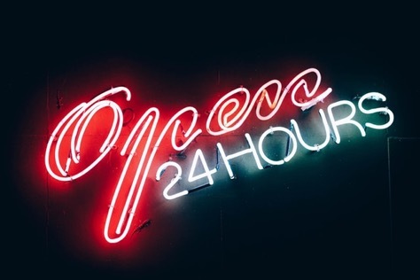 Open all hours’ notice sign in lights. Open all hours’ notice sign in lights.