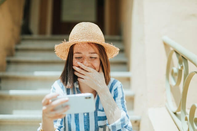 A girl laughing at her phone. A girl laughing at her phone.