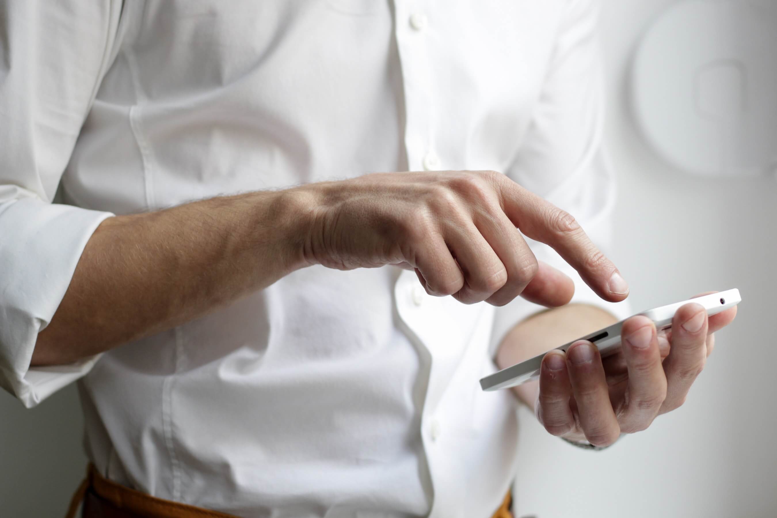 man using his phone to contact a business man using his phone to contact a business