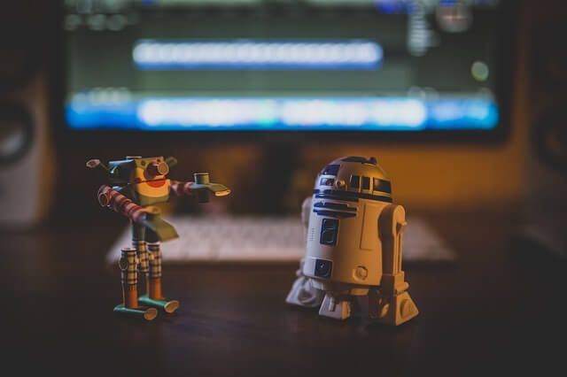 Two robot toys on desk. Two robot toys on desk.