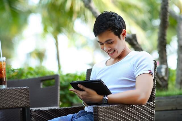 A man using his tablet. A man using his tablet.