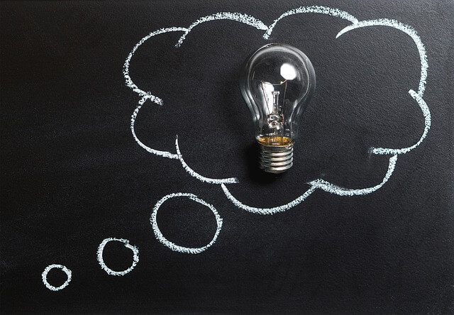A lightbulb in a chalk thought bubble. A lightbulb in a chalk thought bubble.