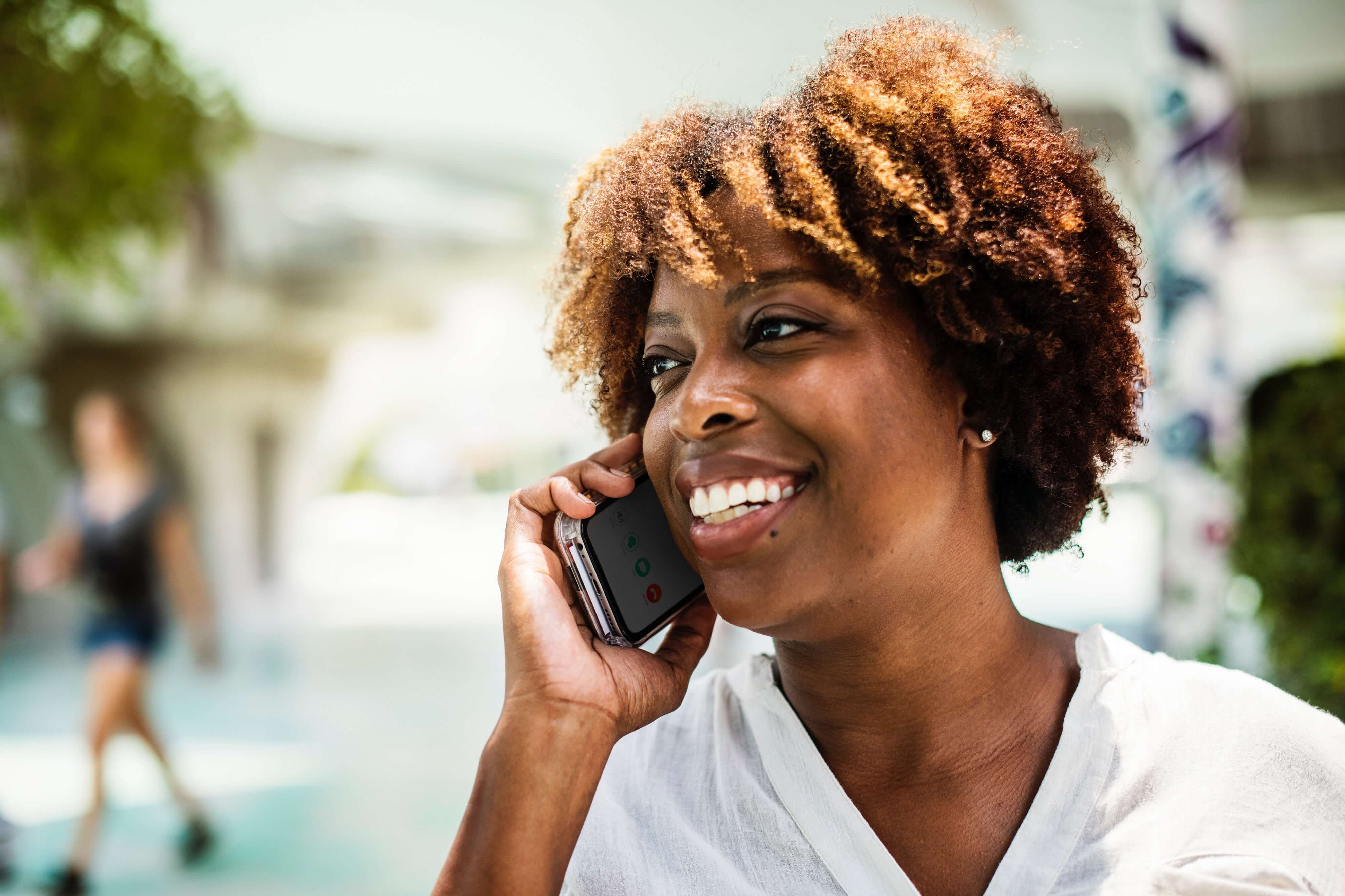 A woman on the phone, smiling. A woman on the phone, smiling.
