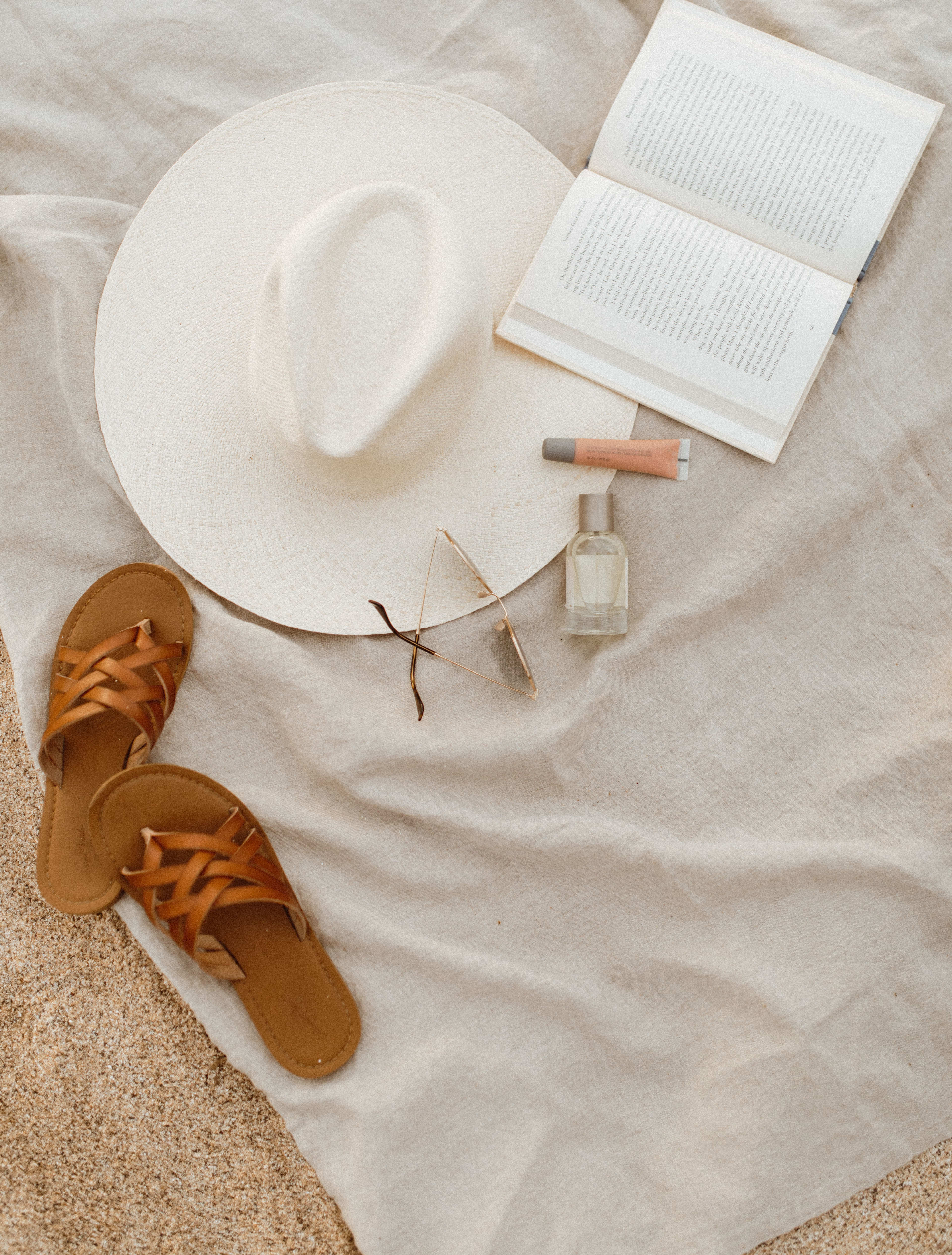 Styled flatlay of lifestyle items on beach in Hawaii