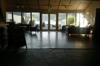 HI Voss : View of Patio and Lake from Lounge Area in Voss Hostel, Norway