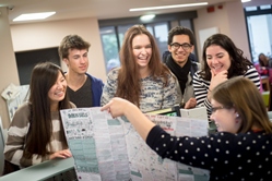 People at reception looking at map