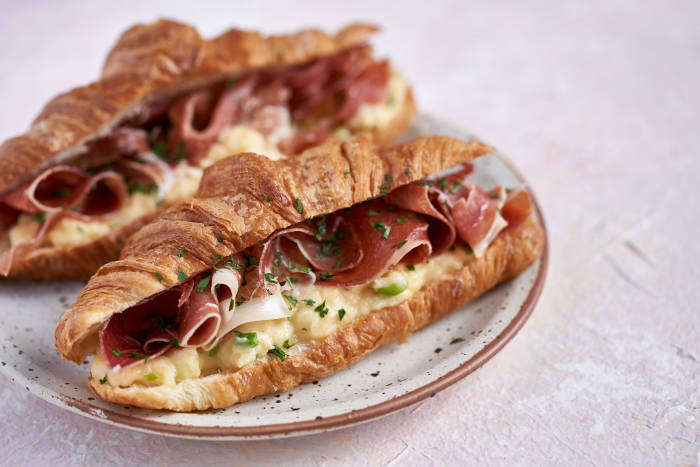 Croissant with serrano ham and Cheddar and spring onion scrambled eggs