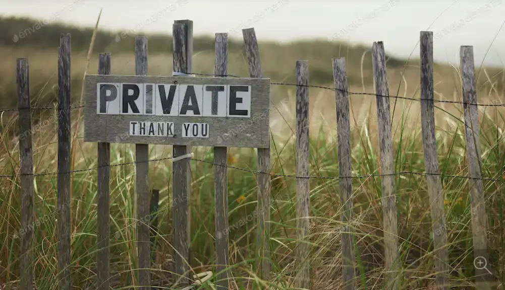 Private property sign on wooden boundary fence.