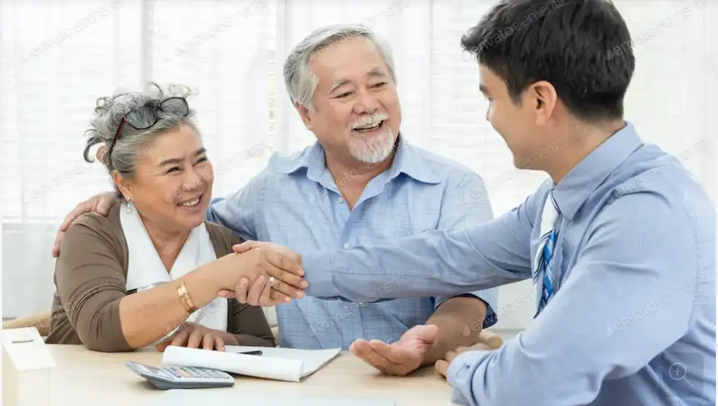 Happy couple shaking hands with home buyer