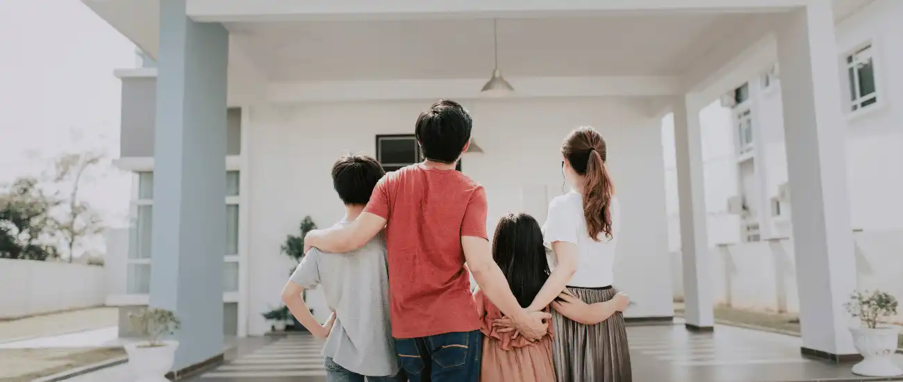 family holding each other looking at home