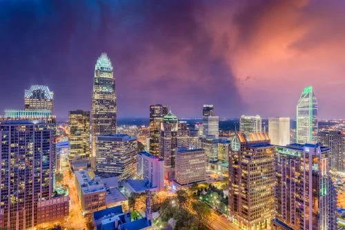 Charlotte skyline and growing suburban real estate market across the greater metro region