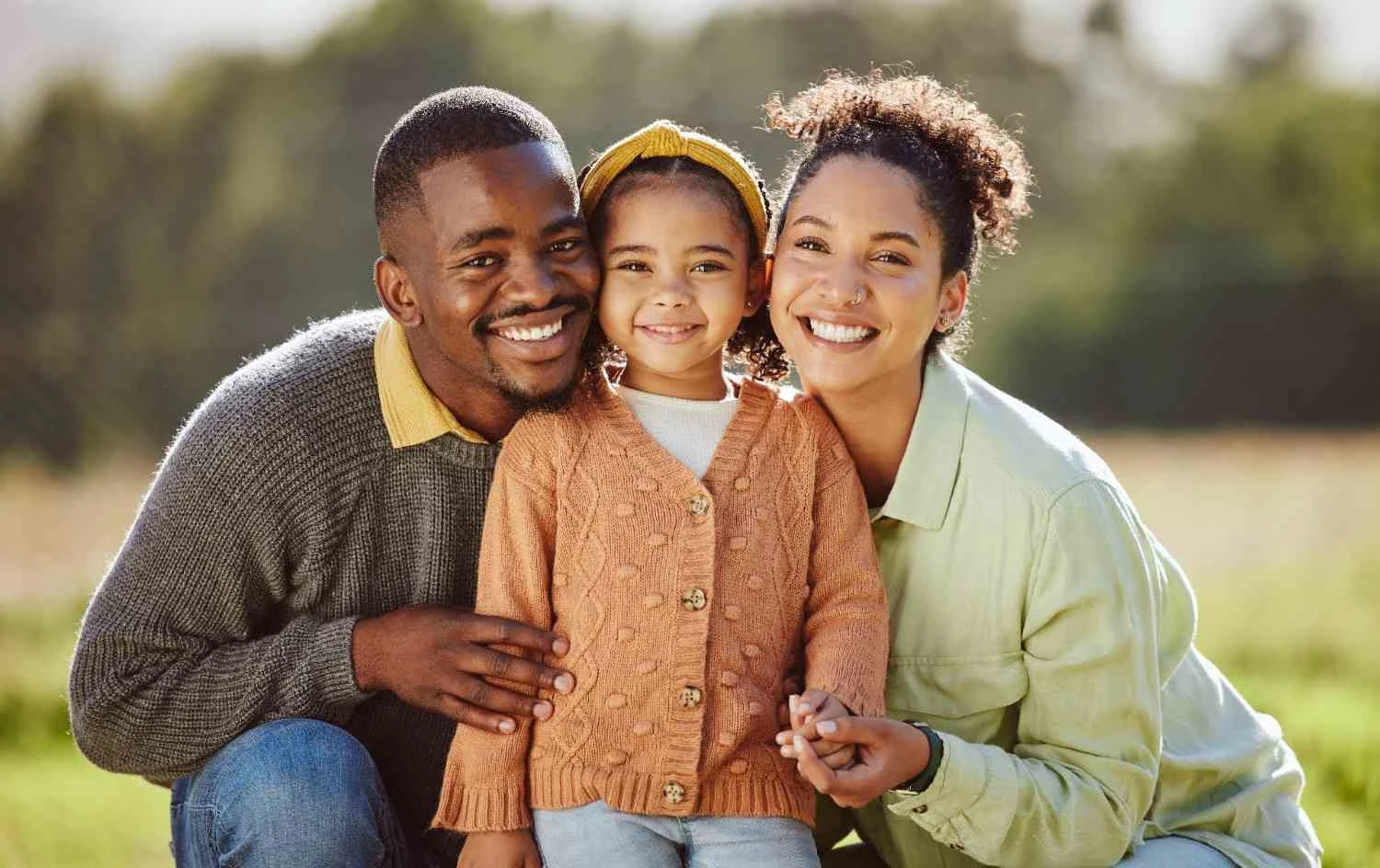 A happy Black family with their child bonding in a Silver Spring community park
