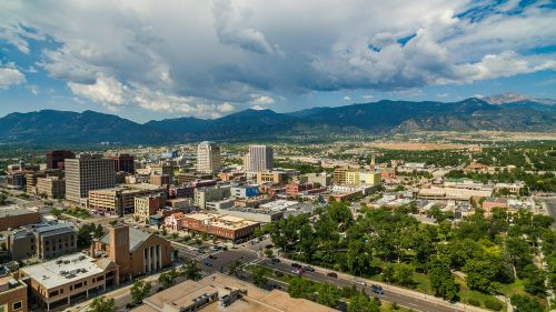 Colorado Springs skyline and mountain metro real estate market spanning nearby suburban communities