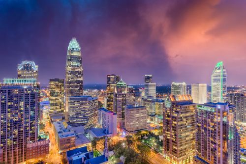 Charlotte skyline and growing suburban real estate market across the greater metro region