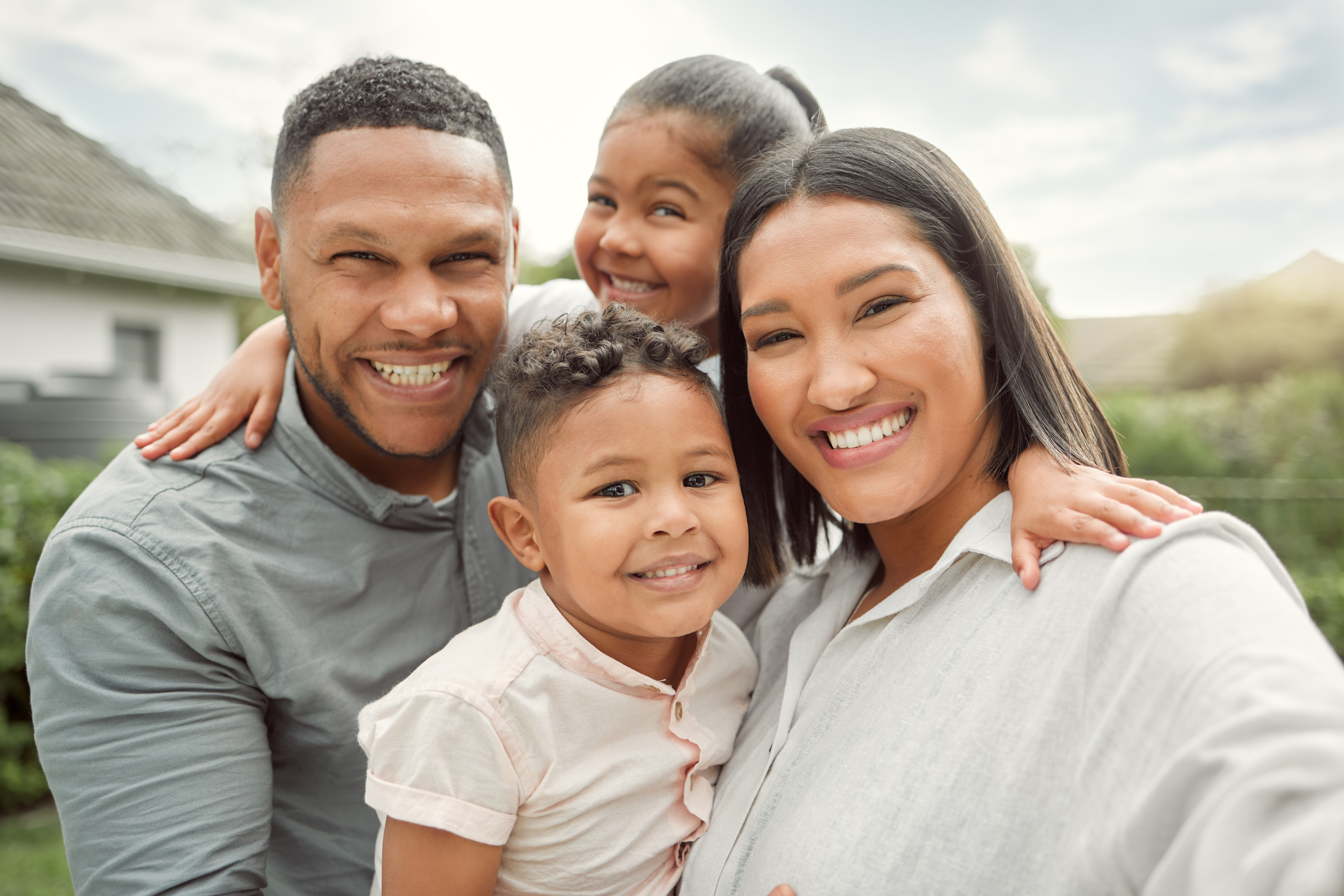 A happy, diverse family hugging together in their Alexandria, VA home