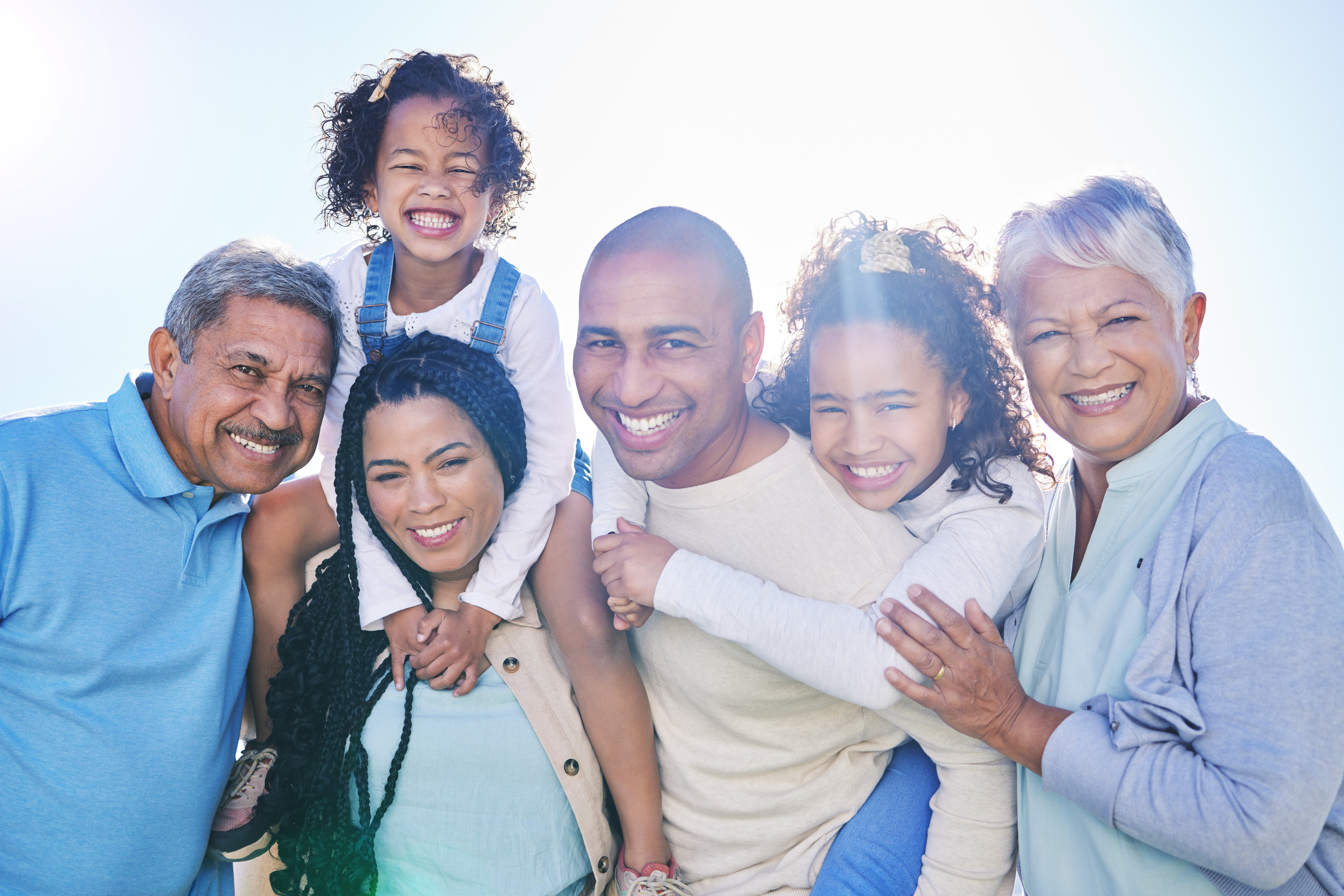 A happy family portrait with children on their parents' shoulders in Pasadena, MD