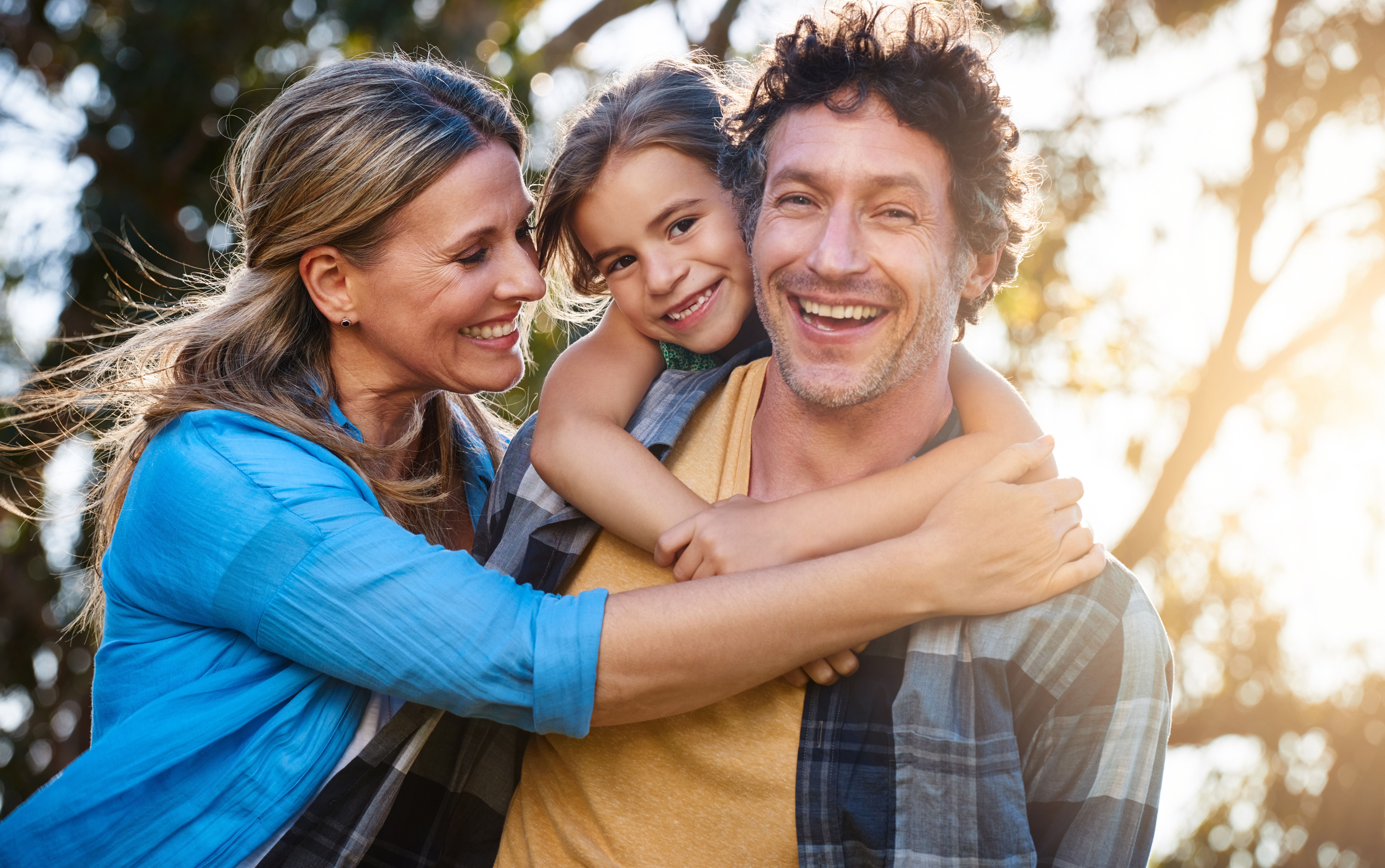 A happy father and daughter smiling together during a family portrait in a Rockville, MD neighborhood