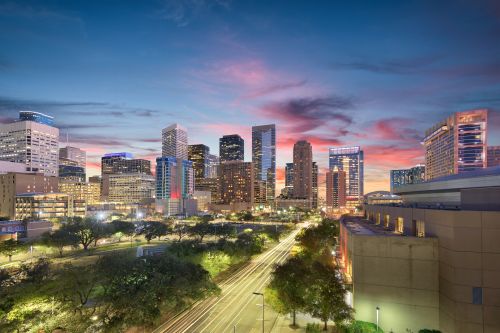 Houston skyline and large metro real estate market with housing activity across surrounding suburbs
