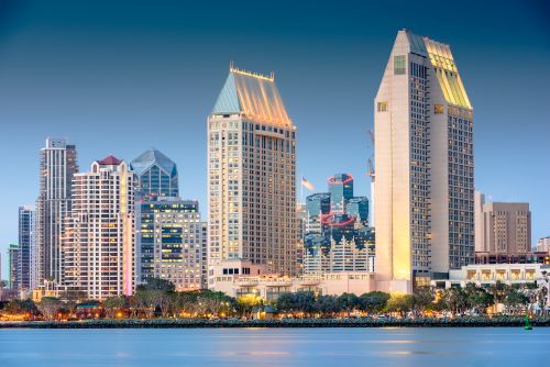 San Diego skyline and coastal real estate market with housing activity across nearby communities