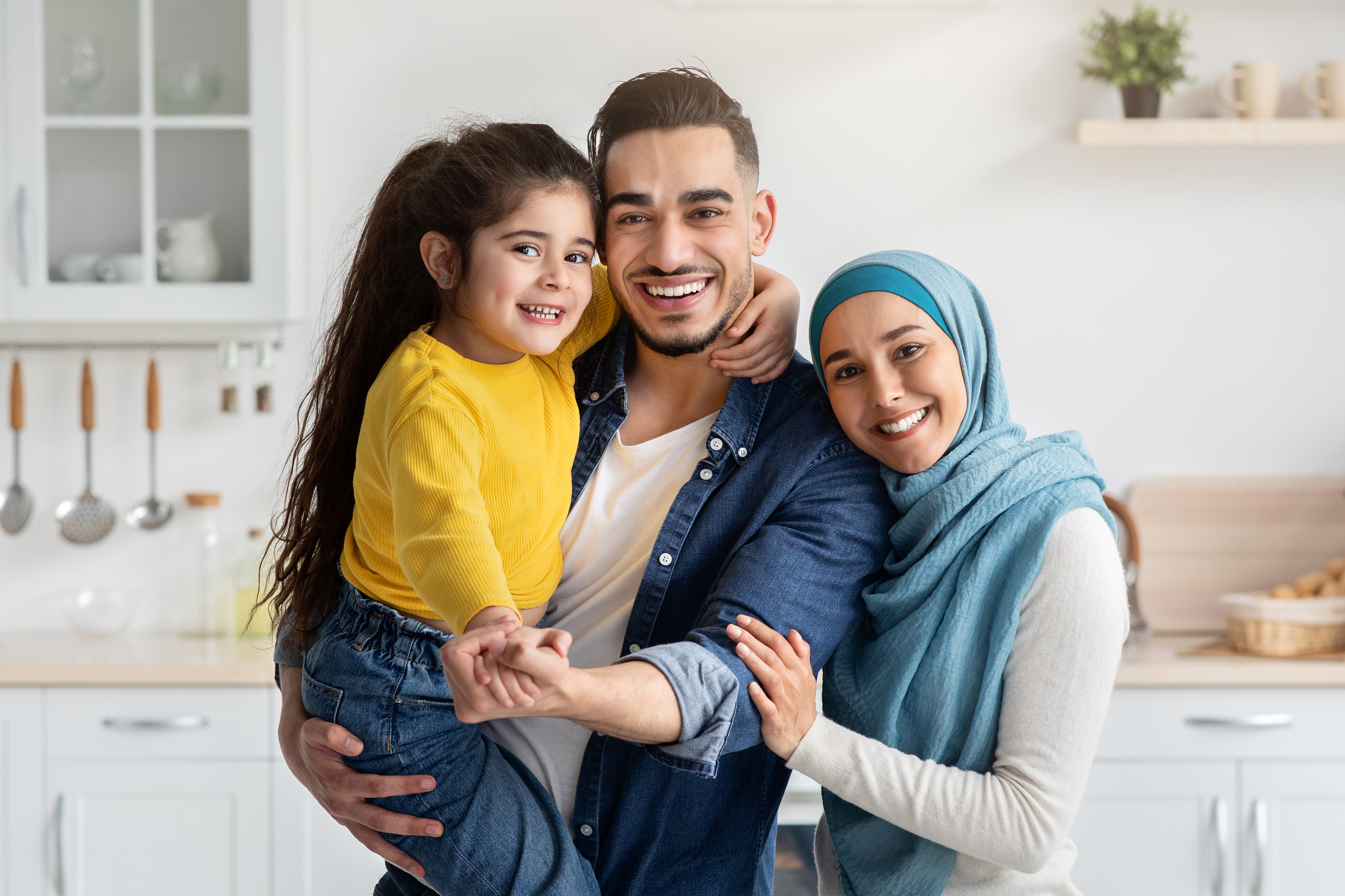 A happy, smiling family bonding together in a bright, modern kitchen in Chesapeake, VA
