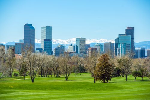 Colorado skyline and mountain-state real estate market with housing activity across metro suburbs and growing regions