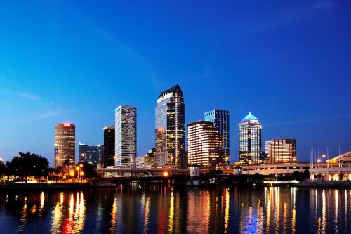 Tampa skyline and Gulf Coast real estate market with housing activity across surrounding suburban communities